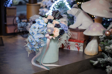 Magnificent floral arrangement of aster, roses and hydrangea, orchids in box decorated with ribbon.