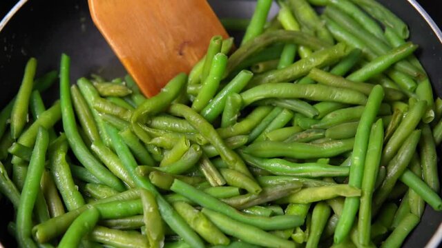 Close up view of green beans on a frying pan. Bio green beans. healthy and healthy food