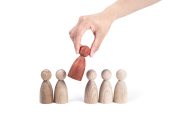 Hand picking up a red figurine from a row of others- strategy concept