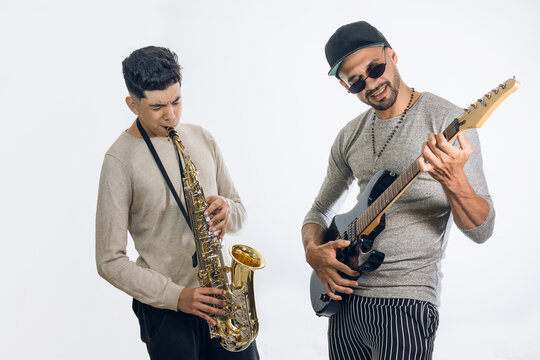 Two young latin men playing a saxophone and an electric viola