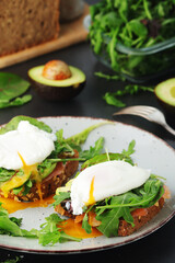 Homemade sandwiches with salmon, avocado and poached eggs