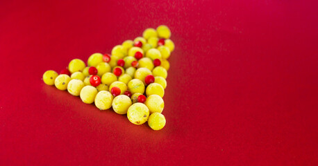 christmas tree made from gooseberries and cranberries on red background