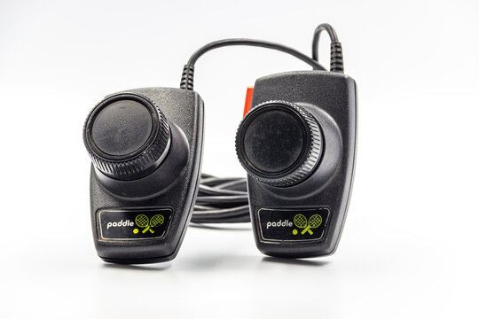 A Studio Shot Of A Atari 2600 Pong Paddle Controllers Isolated On A White Background.