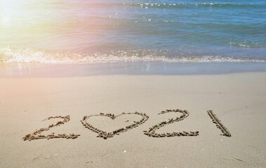 Happy New year 2021 with the waves beat at the beach and shell fragments. Soft focus. Holiday and nature concept.