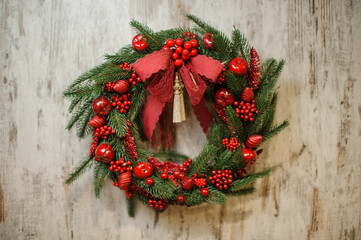 magnificent Christmas wreath of fir branches decorated with bright red berries and bow