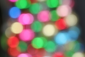 Colorful bokeh background. Lighting of christmas tree, low key. Holiday and background concept.