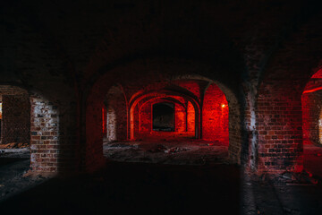 Dark and creepy vaulted red brick dungeon