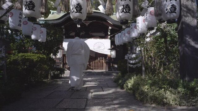 Japanese buddhist man walking in a temple in Osaka, Japan.