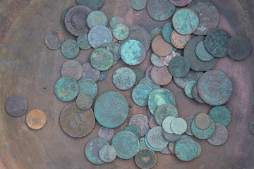  Ancient copper coins on a copper surface. Green copper coins.