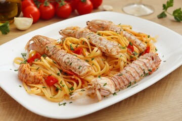 Italian Traditional Dish"Linguine with mantis shirmps" on white plate with wooden table background
