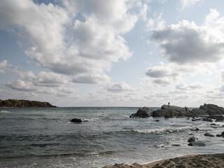 Coast of sea with clouds and sand of beach