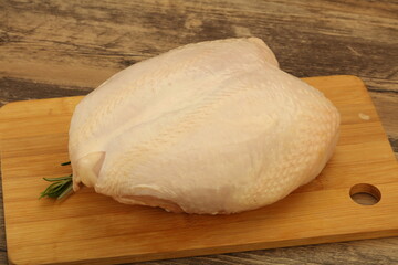 Raw whole chicken breast with skin