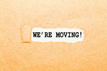 text WE'RE MOVING on a torn piece of paper, business concept