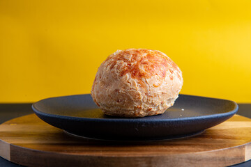 pão de queijo with yellow background