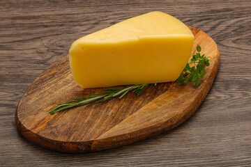 Hard cheese piece served rosemary