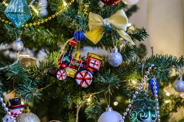 Christmas toy hanging on a Christmas tree against the backdrop
