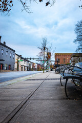 Benches on the Main Street sidewalk in downtown district of Nicholasville, Kentucky in front of Jasemine county courthouse