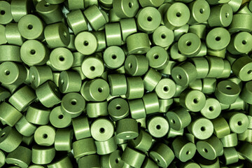 full frame batch of aluminium cylinder parts after anodizing with filling in green chromate...