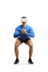 Fit muscular guy exercising with a VR headset
