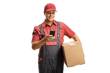 Male courier in a uniform holding a box and typing on a mobile phone