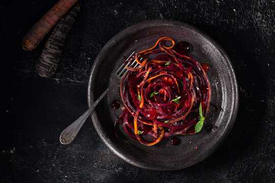 Vegetable spiral salad made from red, orange beets and carrots