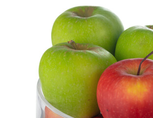 Close up of a glass fruit bowl with apples on white background
