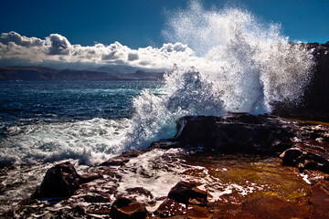 Huge wave hits the coast. The beach near Las Palmas on sunny day in summer, Gran Canaria, Canary Island, Spain