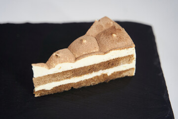 Delicious cake on a black tray. Top view