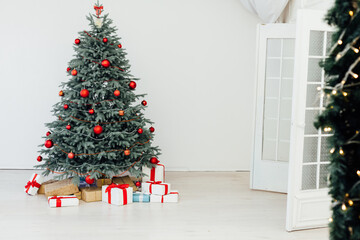 Beautiful holdiay decorated room with Christmas tree with presents under it