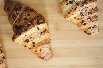 Close up of golden croissants on a wooden tray