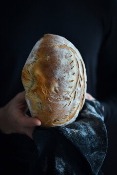 Man holding olive bread in his hands