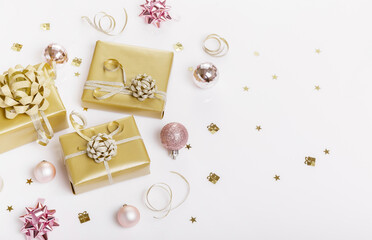 Fototapeta na wymiar Christmas holiday composition. Festive creative golden pattern, xmas gold gift, decor holiday ball with ribbon, snowflakes, on white background.