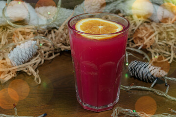 A glass of warm warming drink with an orange slice. Close-up.