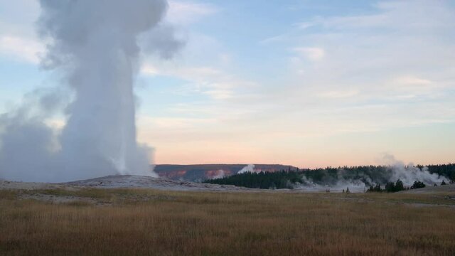 Old faithful at erupting at dawn with no one around. Time lapse.