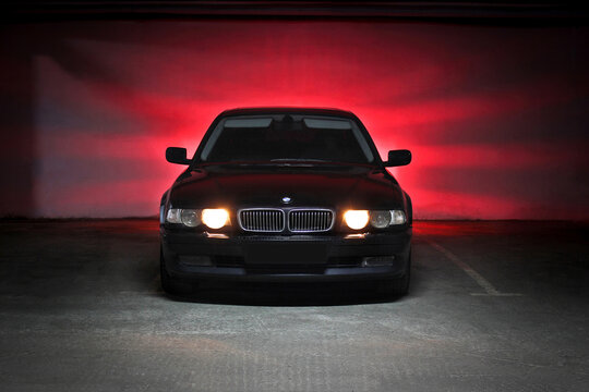 Chernihiv, Ukraine - December 23, 2014: underground parking. BMW 7 (e38) in the shadows with glowing lights in low light