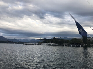 view of cityscape and swiss flag near the river Reuss, Lucerne, Switzerland