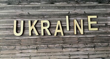 The word Ukraine in wooden letters on a wooden background . Name of the country or geographical location