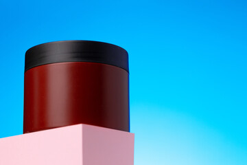 Skincare beauty products container against blue background