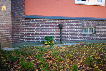 Hedgehog house in front of house facade, winter