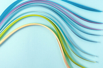 top view of multicolored paper waves on blue background for text or logo