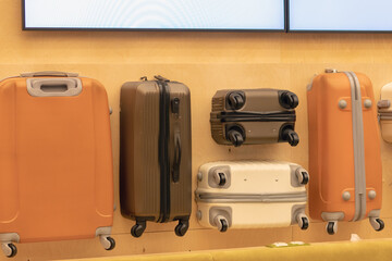Set of suitcases on wooden background in airport- Image