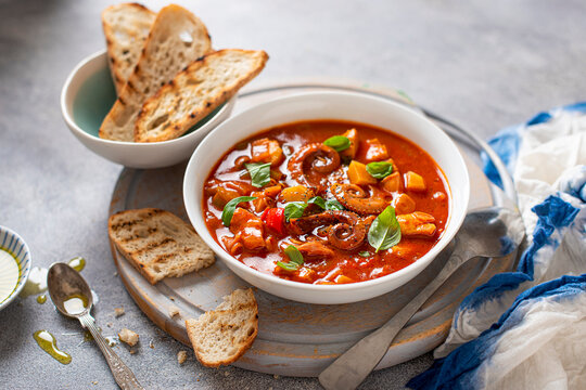 Mediterranean fish and octopus chowder with olive oil, toasted bread and fresh basil