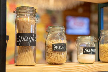 set of kitchen jar with pasta, sugar and penne. cooking concept.