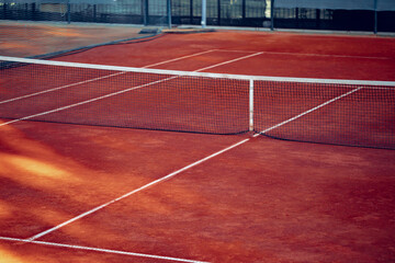 Empty lined clay tennis field and net