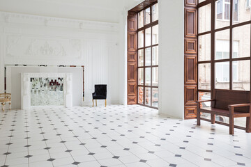Huge luxury white hall with unique interior. Black and white tiles on the floor, white and black...