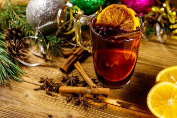 Christmas mulled wine with spices and Christmas decoration on wooden table