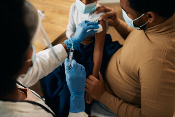 Close-up of a doctor vaccinating a child during coronavirus pandemic.