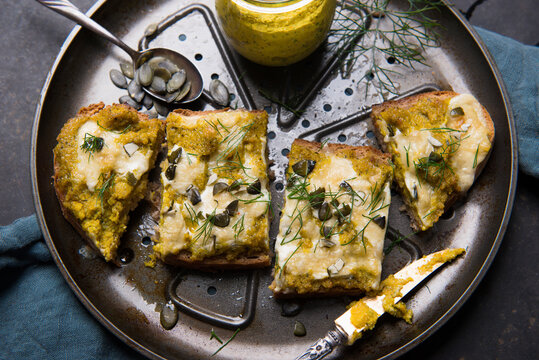 Baked bread with Hokkaido spread, vegan cheese, pumpkin seeds and dill