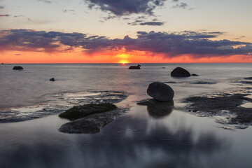 Fototapeta na wymiar Beautiful colorful sunset over sea and rocks. Baltic sea. Estonia. Long exposure.