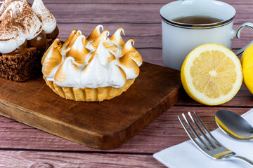 Mini chocolate and lemon pie cake with cup of tea.
